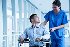 Patient being pushed in wheelchair